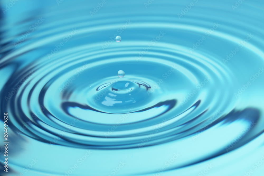 Splash of blue water with drop, closeup Splash of blue water with drop, closeup