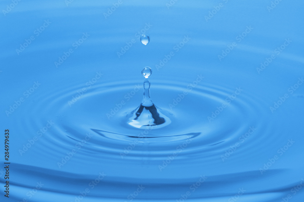 Splash of blue water with drop, closeup Splash of blue water with drop, closeup