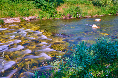 Fototapeta Naklejka Na Ścianę i Meble -  Mountain cold fresh water turquoise color of the Alpine mountains. Photo taken at long exposure.