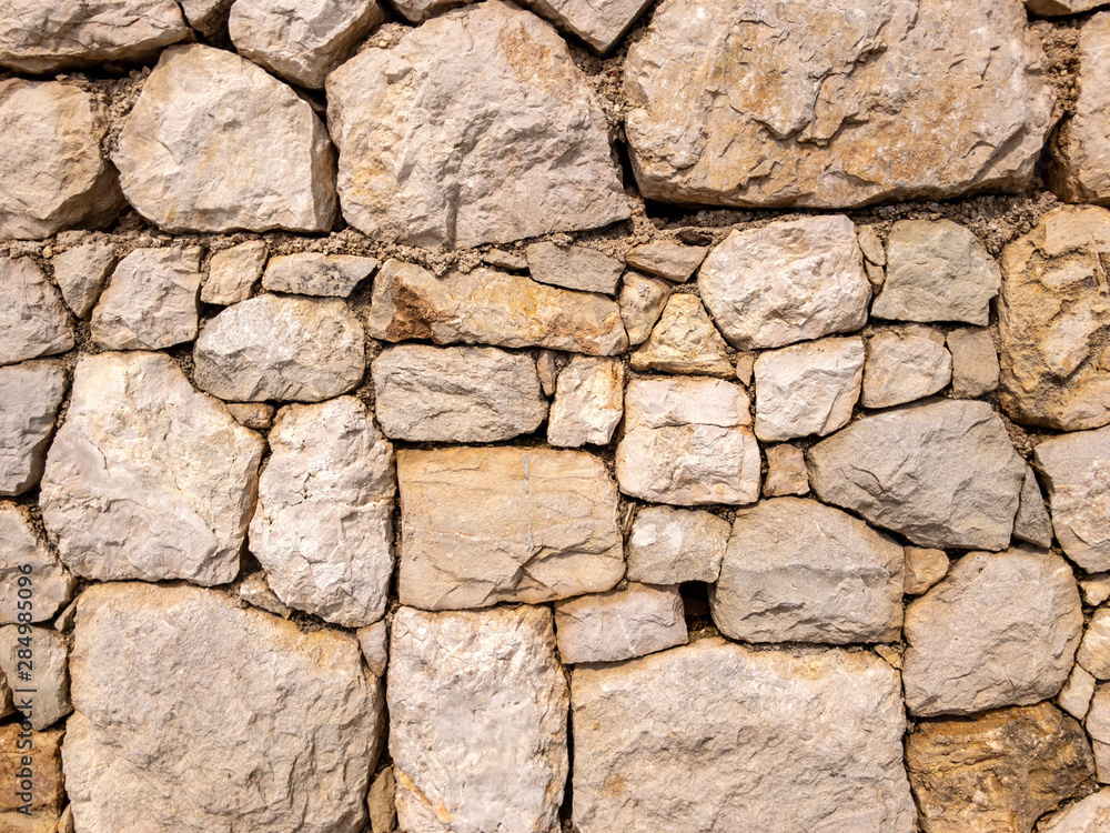 Wall of hard decorative stone. Roughness uneven wall background. Design element, abstract web banner, copy space Wall of hard decorative stone. Roughness uneven wall background. Design element, abstract web banner, copy space