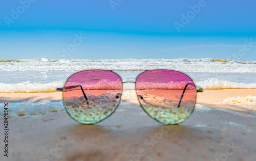 Fototapeta Naklejka Na Ścianę i Meble -  Sunglasses on the coastal beaches under the sun