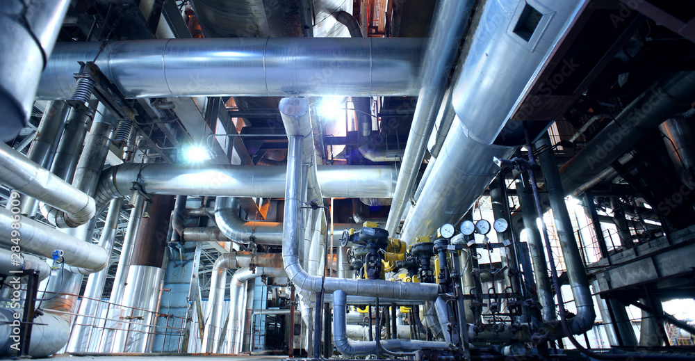Equipment, cables and piping as found inside of a modern industrial power plant Equipment, cables and piping as found inside of a modern industrial power plant
