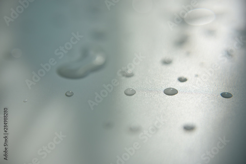 drops of water on white surface with shadow