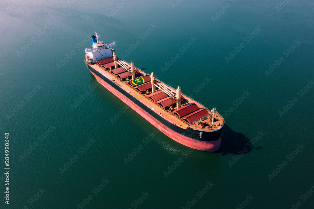 Shipping cargo to harbor by ship. Water transport International. Aerial view