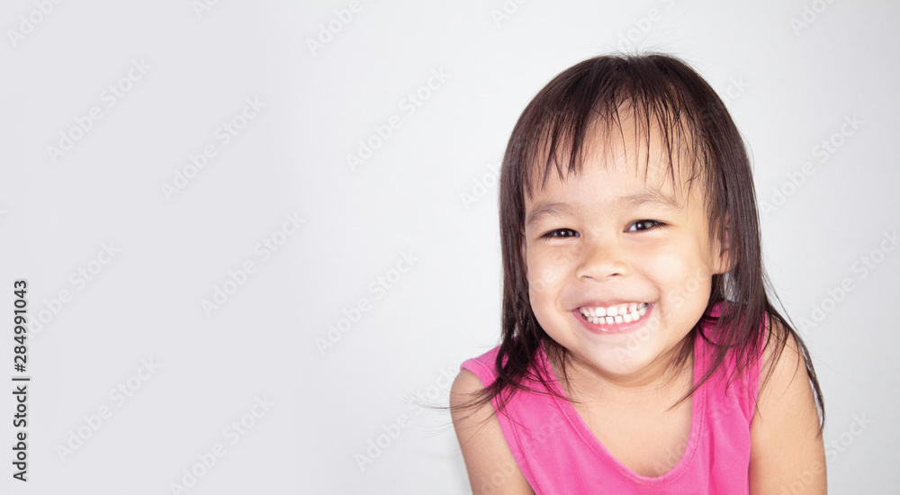 Adorable Asian child smiling and wearing pink dress isolated on a white background. Adorable Asian child smiling and wearing pink dress isolated on a white background.