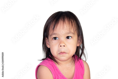Adorable Asian child make doubts face and wearing pink dress isolated on a white background.
