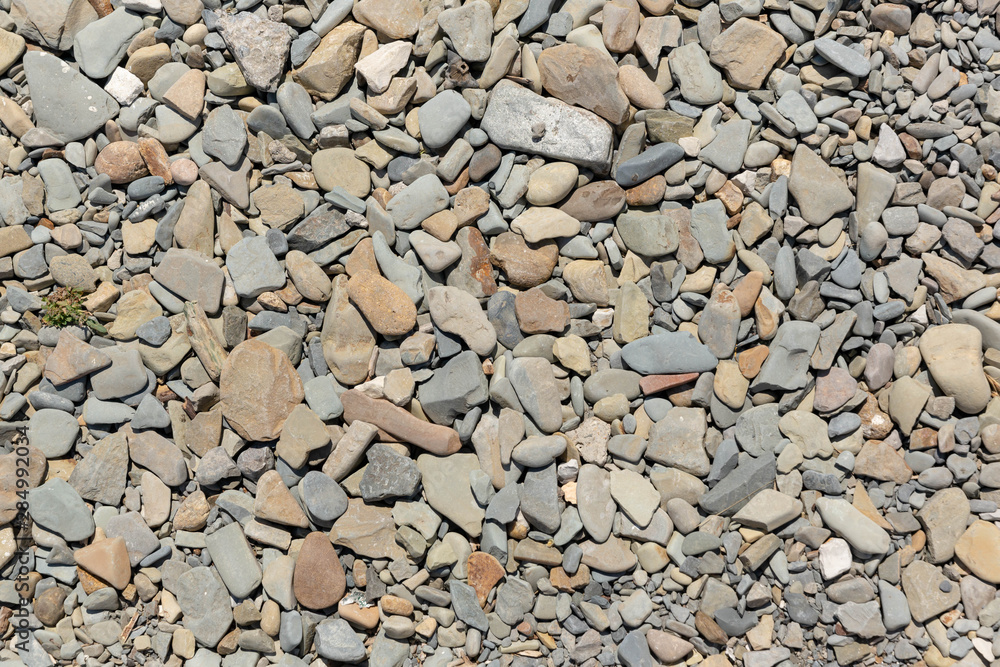 Pebbles on the sea coast, top view. Background image. Pebbles on the sea coast, top view. Background image.