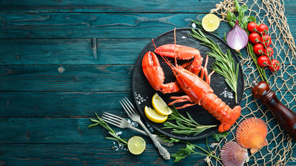 Seafood on a blue background. Lobster. Top view. Free copy space.