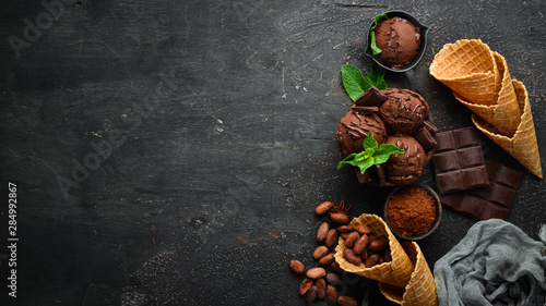 Ice cream with chocolate. Making ice cream on Wooden background. Top view. Free space for your text.