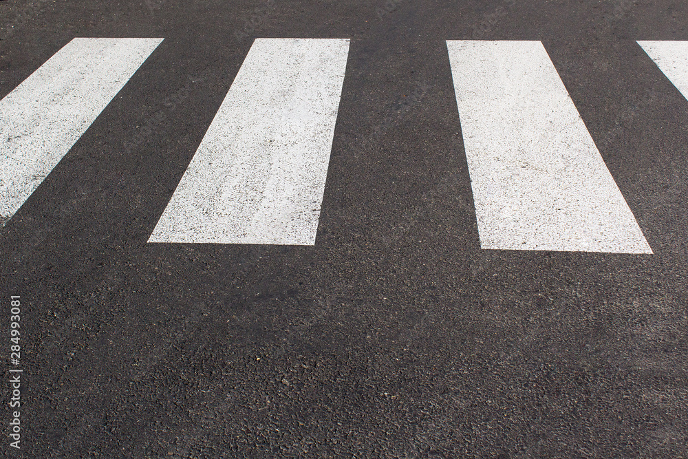 white zebra pedestrian way city lines on the grey asphalt road white zebra pedestrian way city lines on the grey asphalt road
