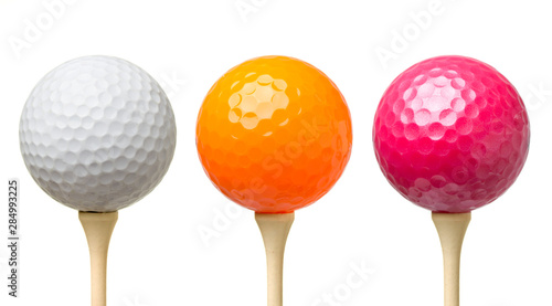 Three golf balls on tee isolated on white background