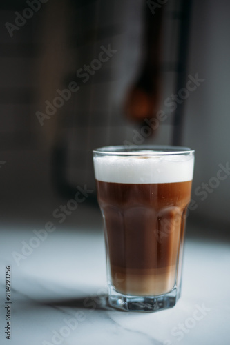Coffee latte macchiato with vegan coconut milk in a glass