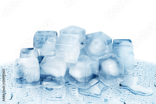 Ice cubes on white glass mirror background with reflection isolated close up, transparent frozen crushed blue ice cubes, clear melted spilled cool water drops, cold fresh drinks ingredient, copy space