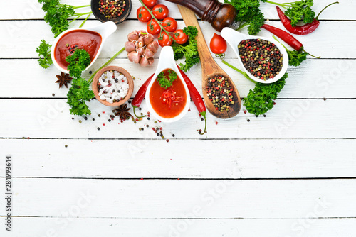 Barbecue sauce. Tomatoes, spices and herbs. Top view. Free space for your text.