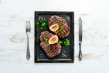 Beef shank roasted on a grill on a white background. Top view. Free space for your text.