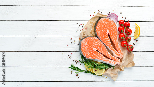 Fresh salmon steak with Ingredients on a white background Wooden. Top view. Free space for your text.