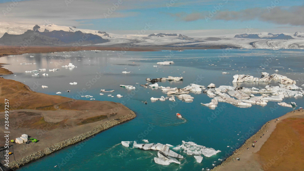 Jokullsarlon glacial lake in southwest Iceland. Panoramic aerial view of icebergs in the lagoon on a sunny day