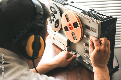 Obraz na plátně Special agent listens on the reel tape recorder