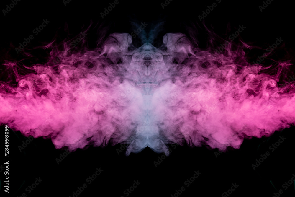 Fototapeta premium Smoke of different blue, red and pink colors in form of horror in the shape of the head, face and eye with wings on a black isolated background. Soul and ghost in mystical symbol. Print for clothes.