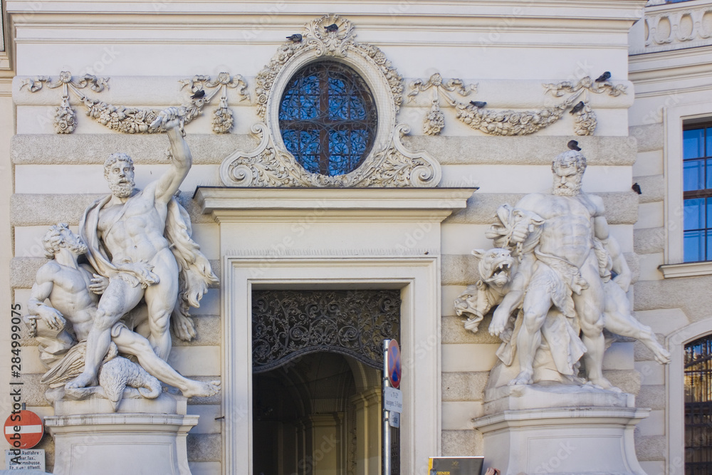 Statues of Hercules and Busiris on the Hofburg - baroque palace complex with museums in Vienna, Austria