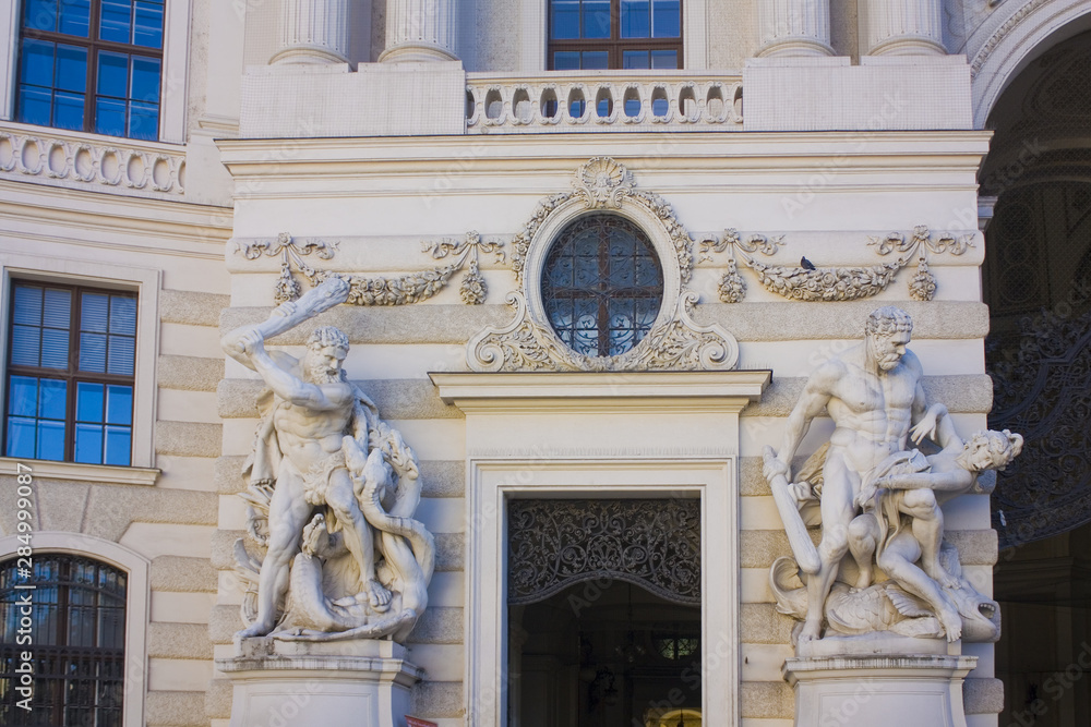 Statues of Hercules and Busiris on the Hofburg - baroque palace complex with museums in Vienna, Austria