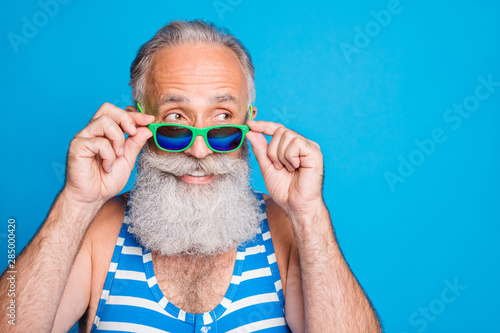 Close-up portrait of his he nice attractive funky cheerful cheery content gray-haired man spending leisure cool carefree life lifestyle isolated over bright vivid shine turquoise blue background
