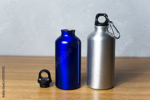 Two miscellaneous thermo bottle on the wooden table