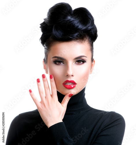 Beautiful young woman with hand near face