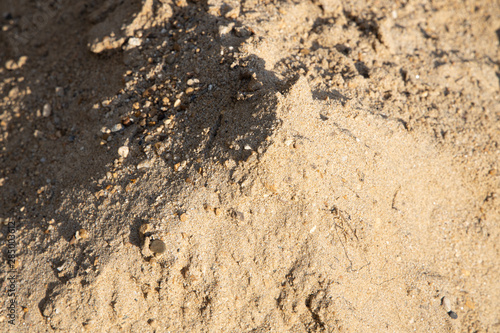 Top of the sand pile With sunshine on one side Causing a shadow on the other side