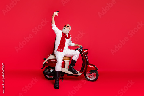 Full length body size view of his he nice attractive well-dressed stylish trendy confident cheerful gray-haired man taking making selfie isolated over bright vivid shine red background