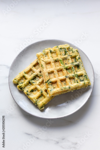 spinach waffles on white marble background with opy space