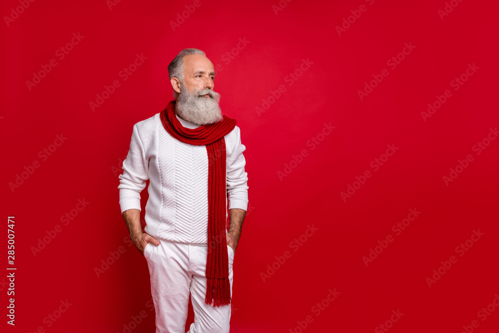 Profile side photo of charming pensioner putting his hands in trousers wearing white pullover pants trousers isolated over red background Profile side photo of charming pensioner putting his hands in trousers wearing white pullover pants trousers isolated over red background