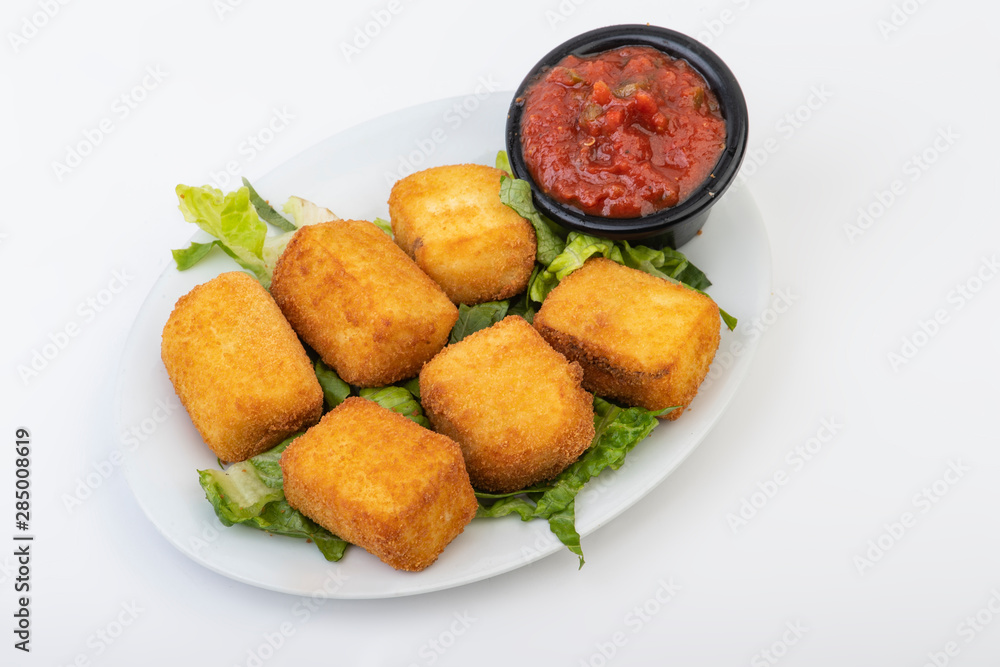 Breaded Cheesy Bites isolated on white, Mini Mozzarella sticks with dip isolated on white Breaded Cheesy Bites isolated on white, Mini Mozzarella sticks with dip isolated on white