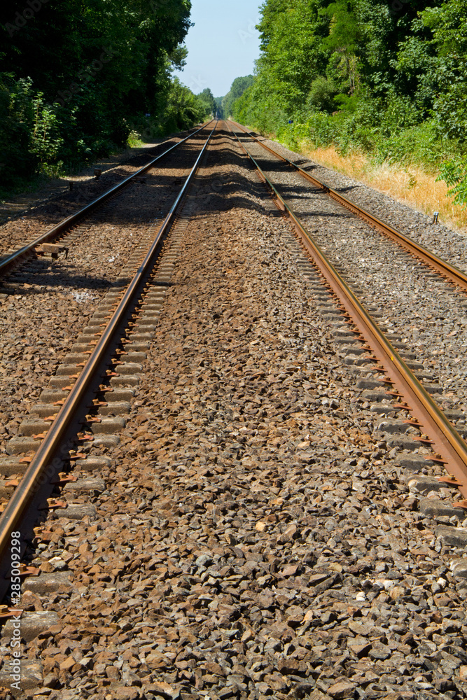 Naklejka premium Railroad tracks on concrete sleepers and ballast bed