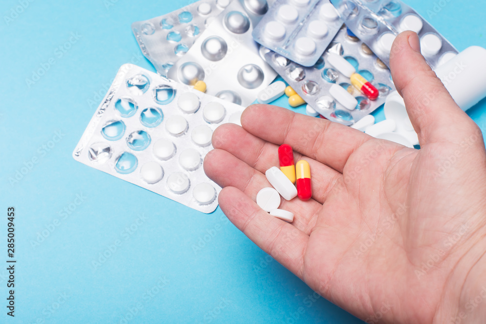 medical tablets in the hand of a person on the background of medicines medical tablets in the hand of a person on the background of medicines