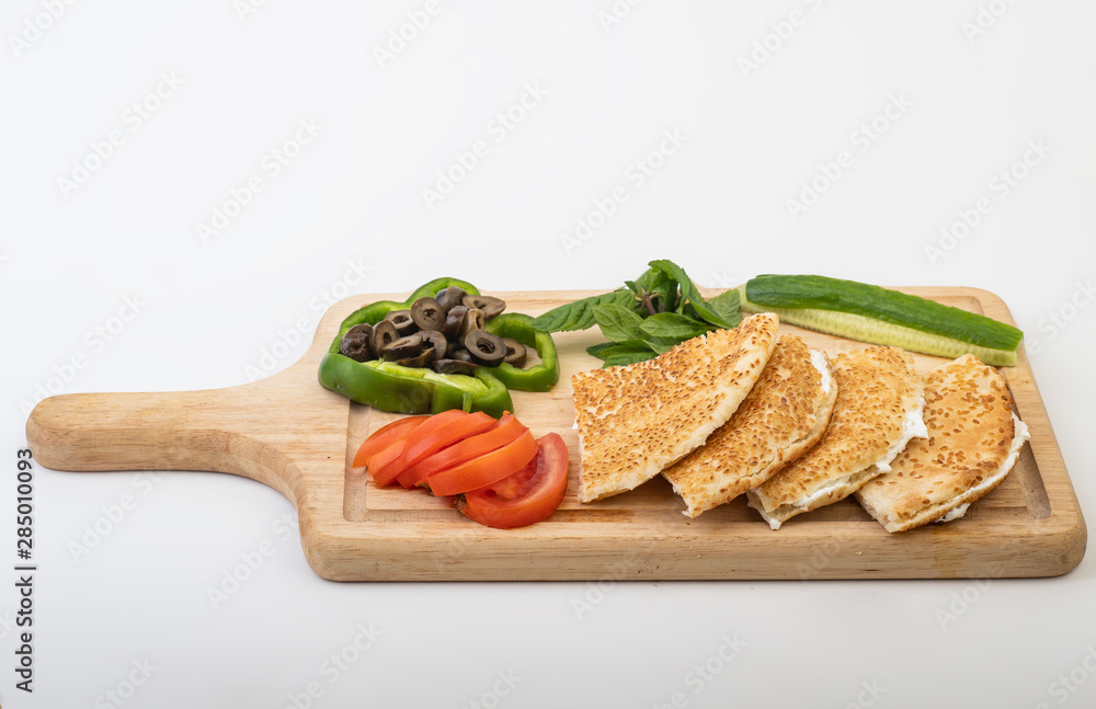 Kaak with labneh served with veggies isolated on white background Kaak with labneh served with veggies isolated on white background
