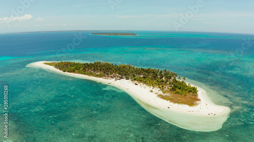 Tropical island Canimeran with sandy beach in the blue sea with coral reef, top view. Summer and travel vacation concept. Balabac, Palawan, Philippines.