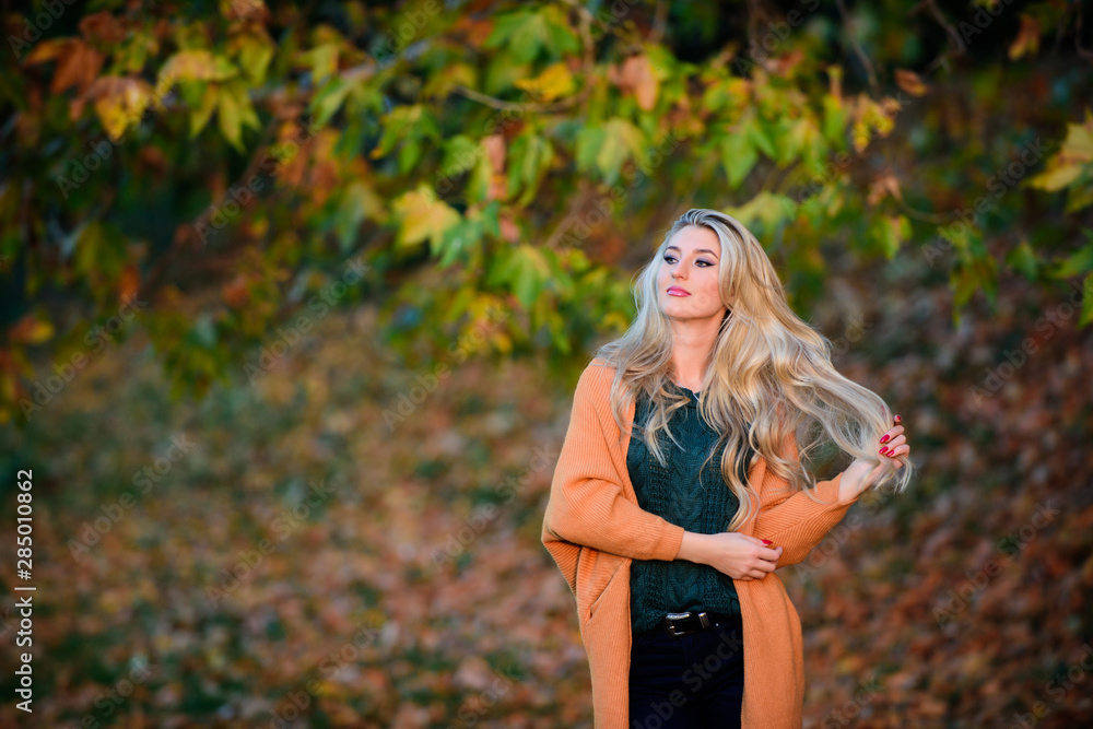 Girl adorable blonde posing in warm and cozy outfit autumn nature background defocused. Cozy casual outfits for fall. Cozy outfit ideas for weekend. Woman walk sunset light. Clothing for every day Girl adorable blonde posing in warm and cozy outfit autumn nature background defocused. Cozy casual outfits for fall. Cozy outfit ideas for weekend. Woman walk sunset light. Clothing for every day
