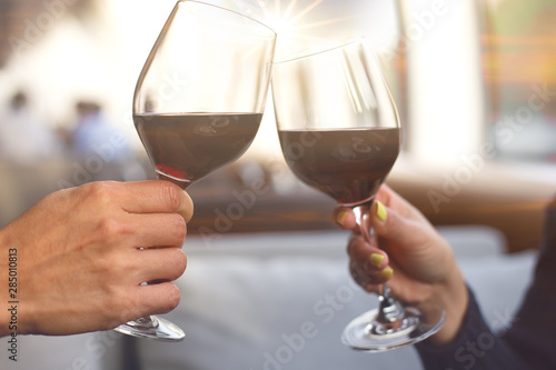 close up hand of romantic couple or friendship which happy moment relaxing ,red,wineglass,celebration on the rooftop with sunset sky scene