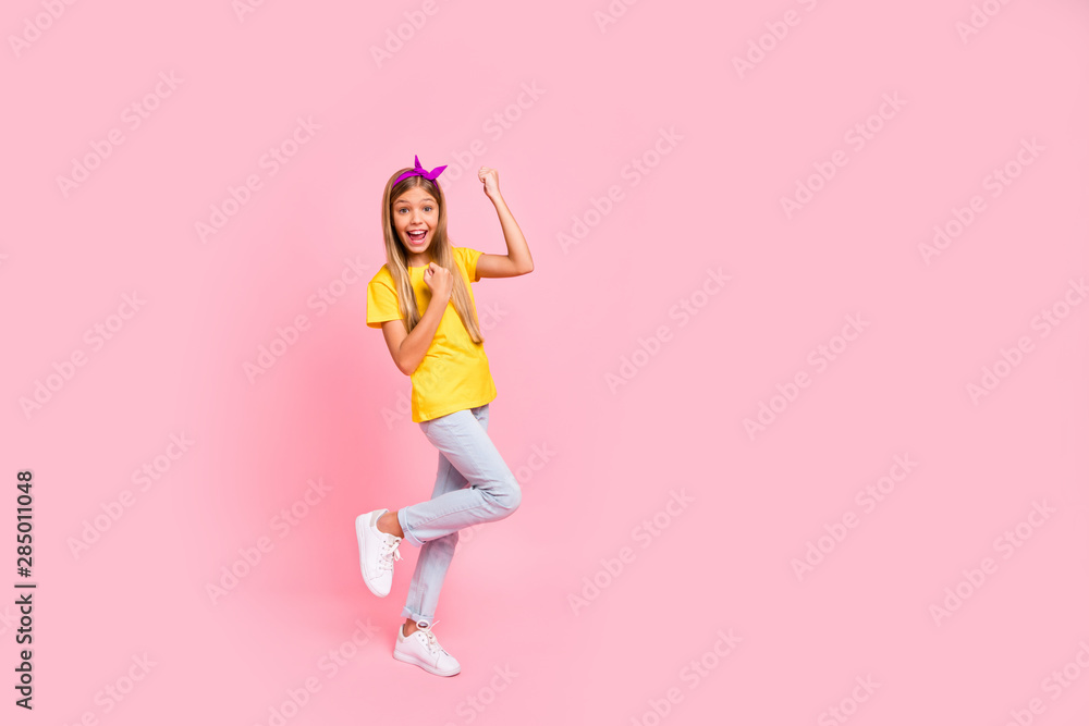 Full length body size view of her she nice attractive lovely cheerful cheery ecstatic pre-teen girl wearing yellow t-shirt having fun party attainment isolated over pink pastel background Full length body size view of her she nice attractive lovely cheerful cheery ecstatic pre-teen girl wearing yellow t-shirt having fun party attainment isolated over pink pastel background