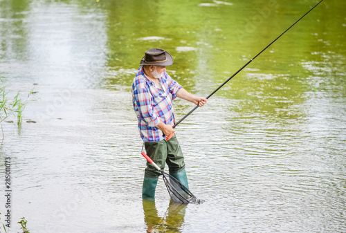 Retired fisherman. Senior man catching fish. Mature man fishing. Male leisure. Fisherman with fishing rod. Activity and hobby. Fishing freshwater lake pond river. Happiness is rod in your hand