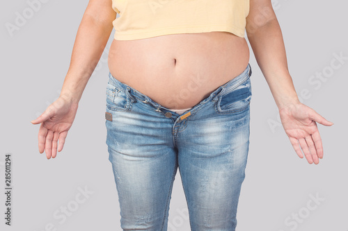 middle-aged woman suffering from obesity , the concept of overweight in the age © Aleksey 159
