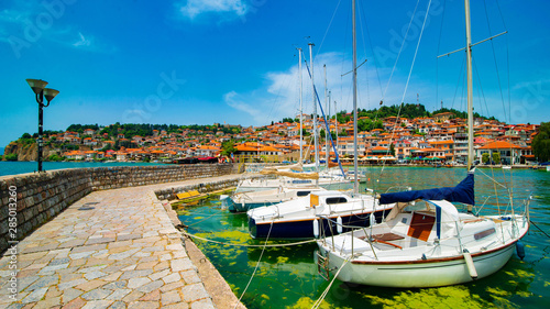Fototapeta Naklejka Na Ścianę i Meble -  North macedonia. Ohrid. Different sail boats in dock on lake with buildings on hill