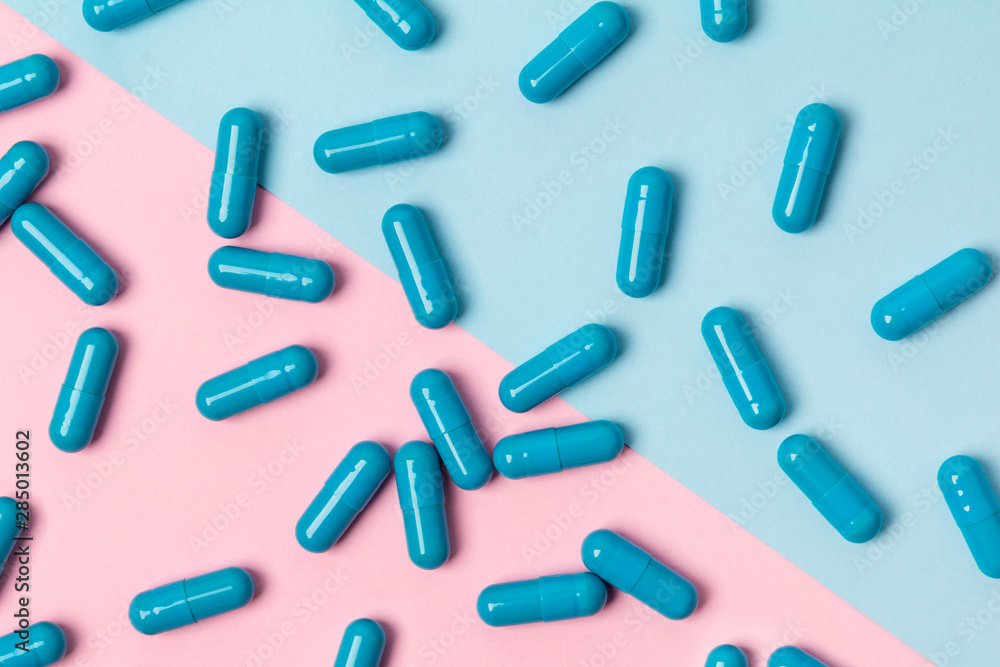 Blue pills at creative background. Medicine concept. Blue pills at creative background. Medicine concept.