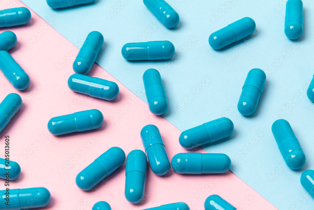 Blue pills on pink background. Template for feminine beauty blog social media Blue pills on pink background. Template for feminine beauty blog social media