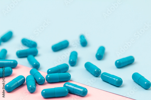 Blue pills on pink background. Template for feminine beauty blog social media