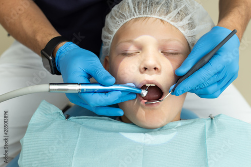 Little boy lays under anesthesia on dentist coach