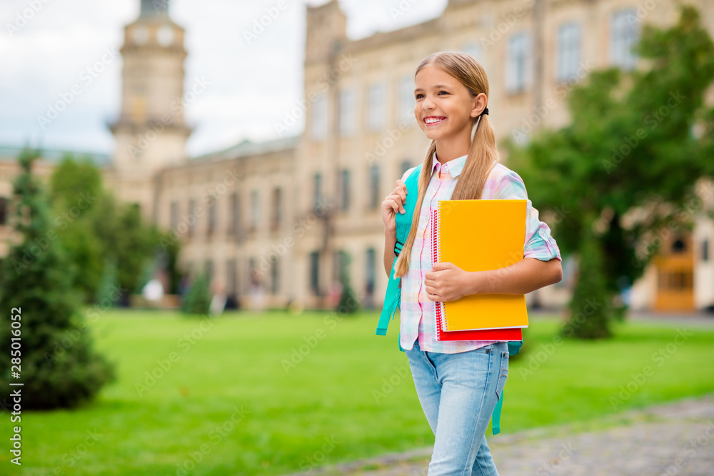 Profile side photo of lovely student holding books rucksack backpack going wearing checkered plaid t-shirt denim jeans outside Profile side photo of lovely student holding books rucksack backpack going wearing checkered plaid t-shirt denim jeans outside