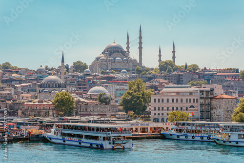 05/26/2019 Istanbul, Turkey, a standard and tourist look at The Blue Mosque also known as Sultan Ahmet. tourist image as a postcard. with boats and ferry on the Bosphorus Strait in the foreground photo