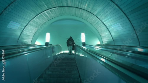 People moving up in escalator in subway metro station. Slow motion, 4K UHD.